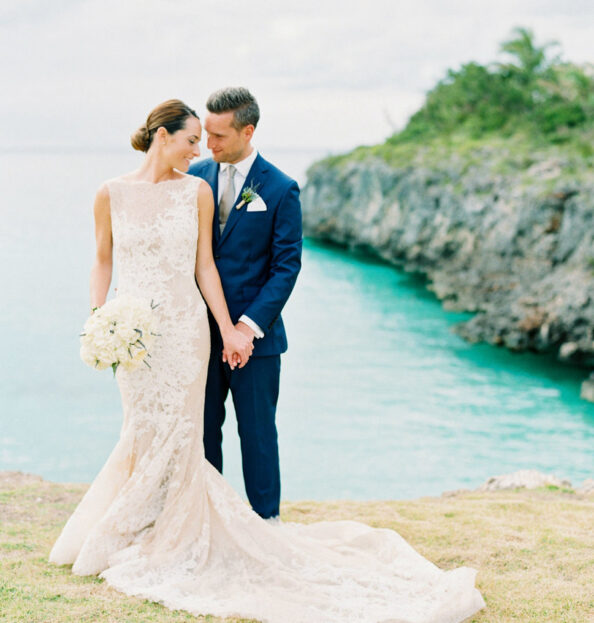 bride and groom next to the water