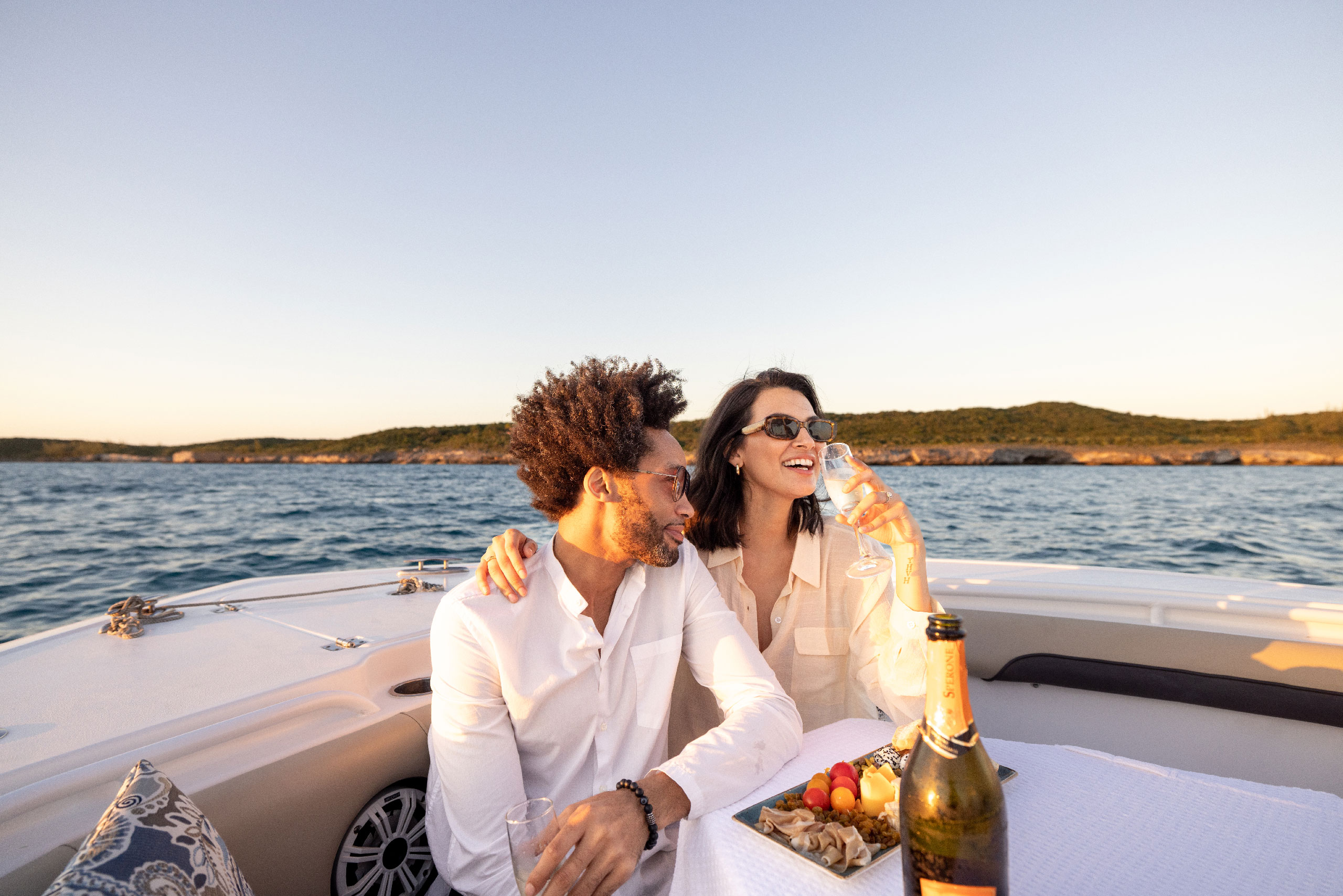 couple on a boat, sipping champagne