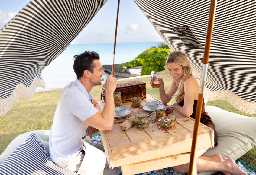 Couple enjoying a picnic under a tent at our Bahamas luxury resort