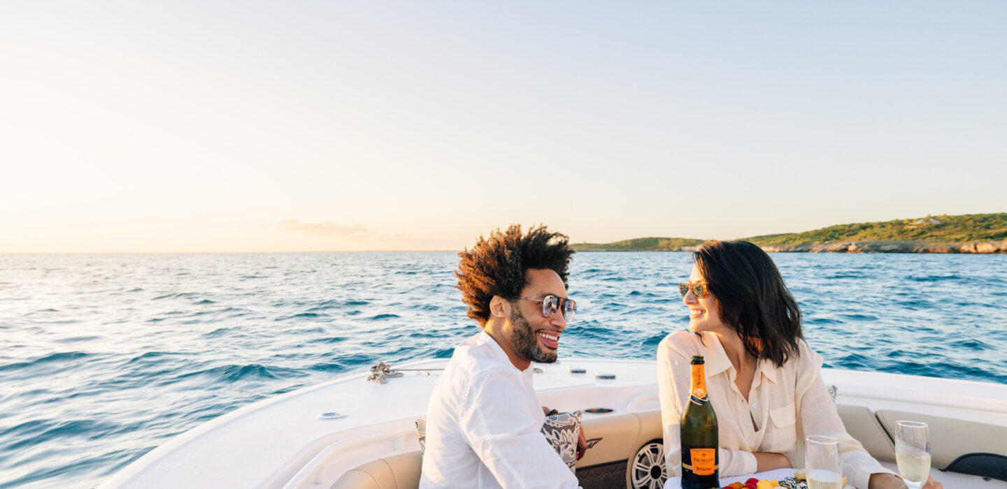 Couple with champagne and fruit on a boat excursion in the Bahamas