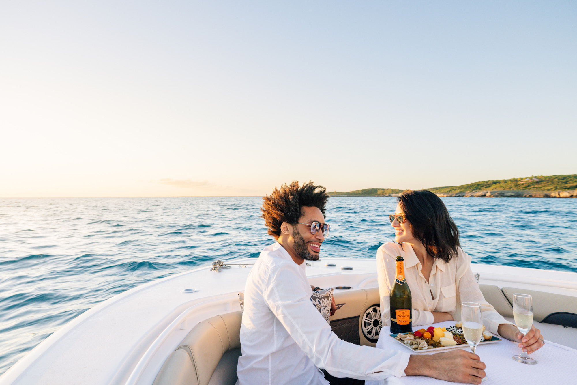 Couple with champagne and fruit on a boat excursion in the Bahamas