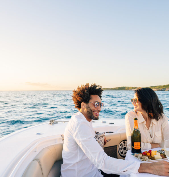 Couple with champagne and fruit on a boat excursion in the Bahamas