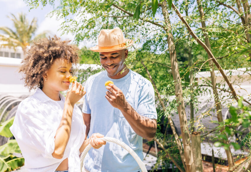 Couple smelling picked flowers at our luxury resort in the Bahamas